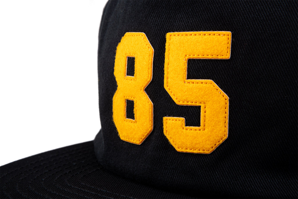 Odyssey '85 5-Panel Hat (Black w/ Golden Rod Felt Applique)